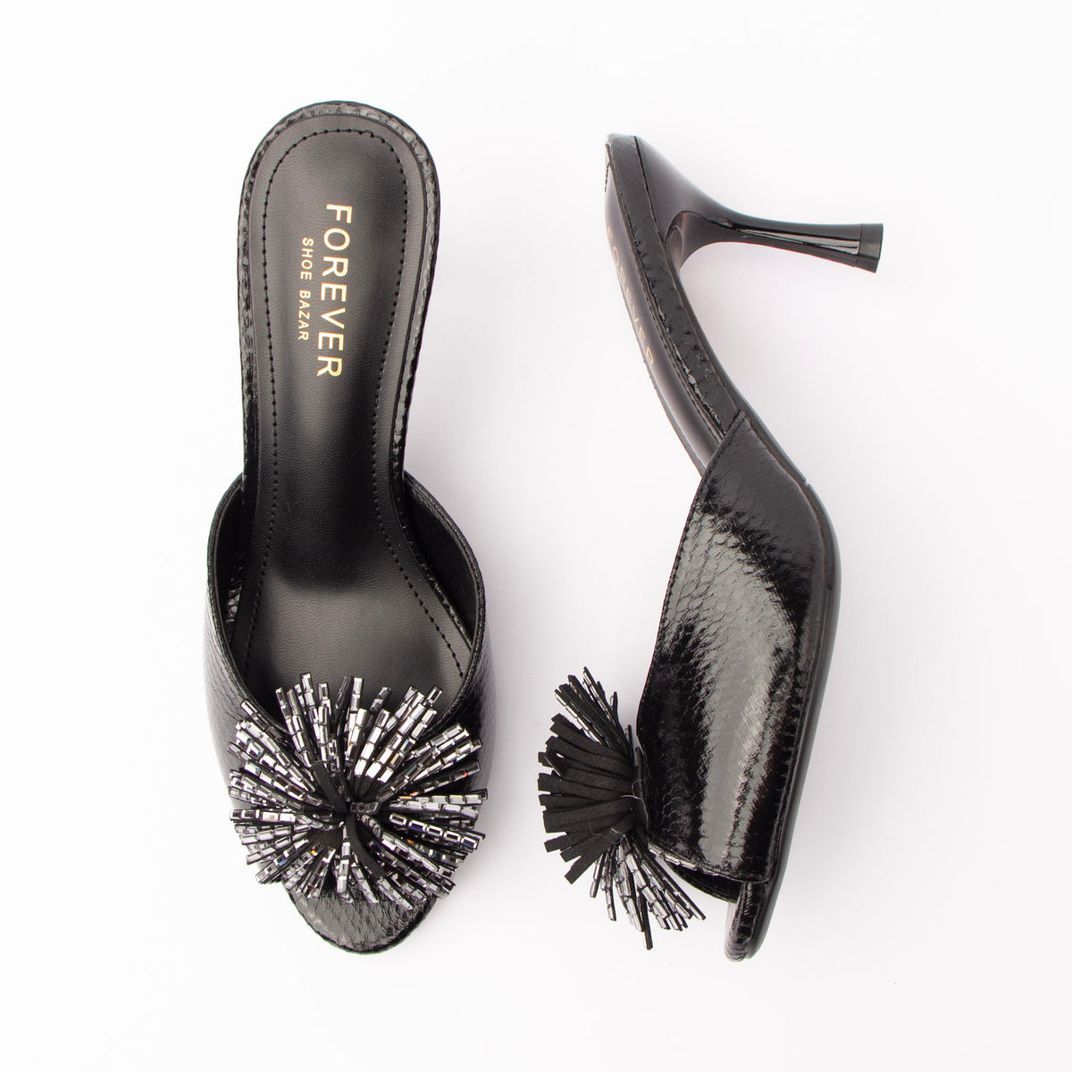 Black mules for women, both shoes laid flat