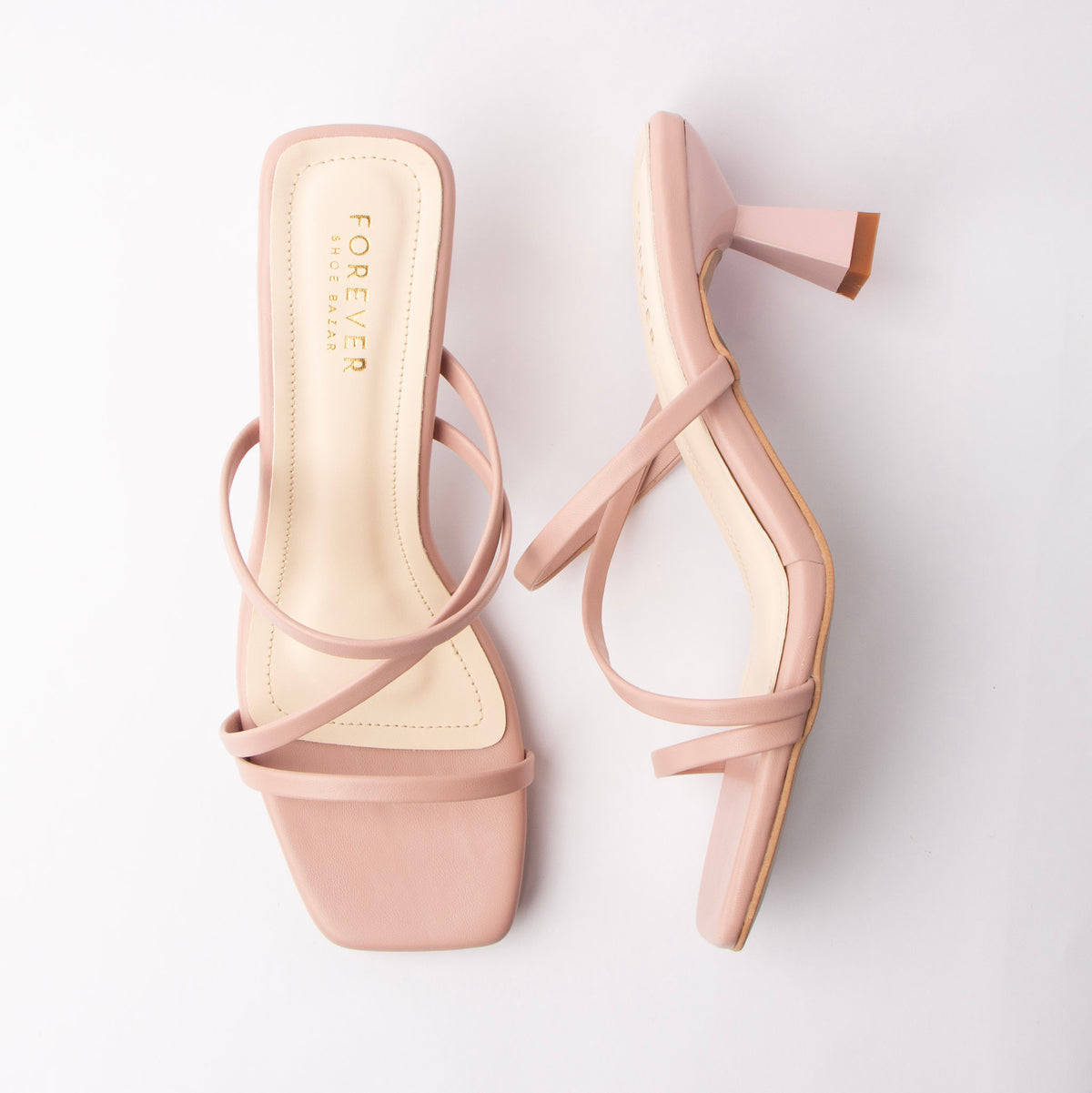 Pink mules for women, both shoes laid flat