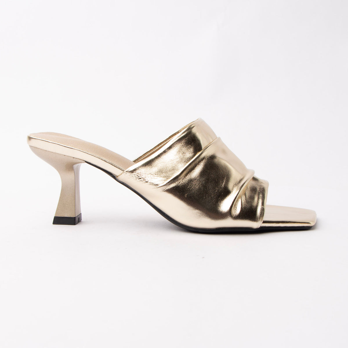 Gold metallic mules for women, one wide panel of mirror-foiled champagne-gold leather gathered across the instep and caught underneath by a slim piped strap over the toes, open through the arch and heel, on a slim flared spool heel in matching foil