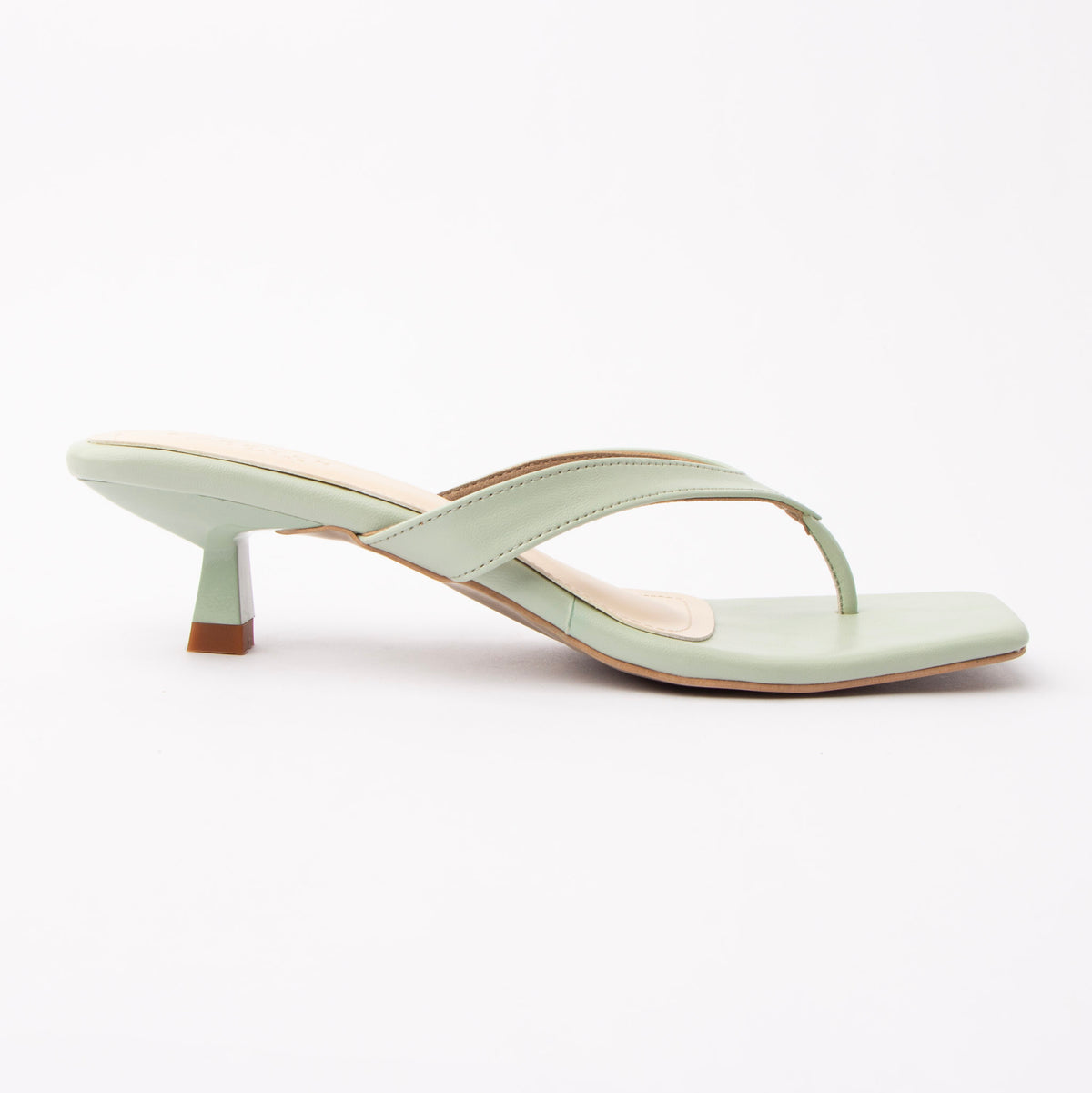 Green toe-post kitten heel mules for women, side view of the twisted vamp band, squared-off open toe and slim kitten heel