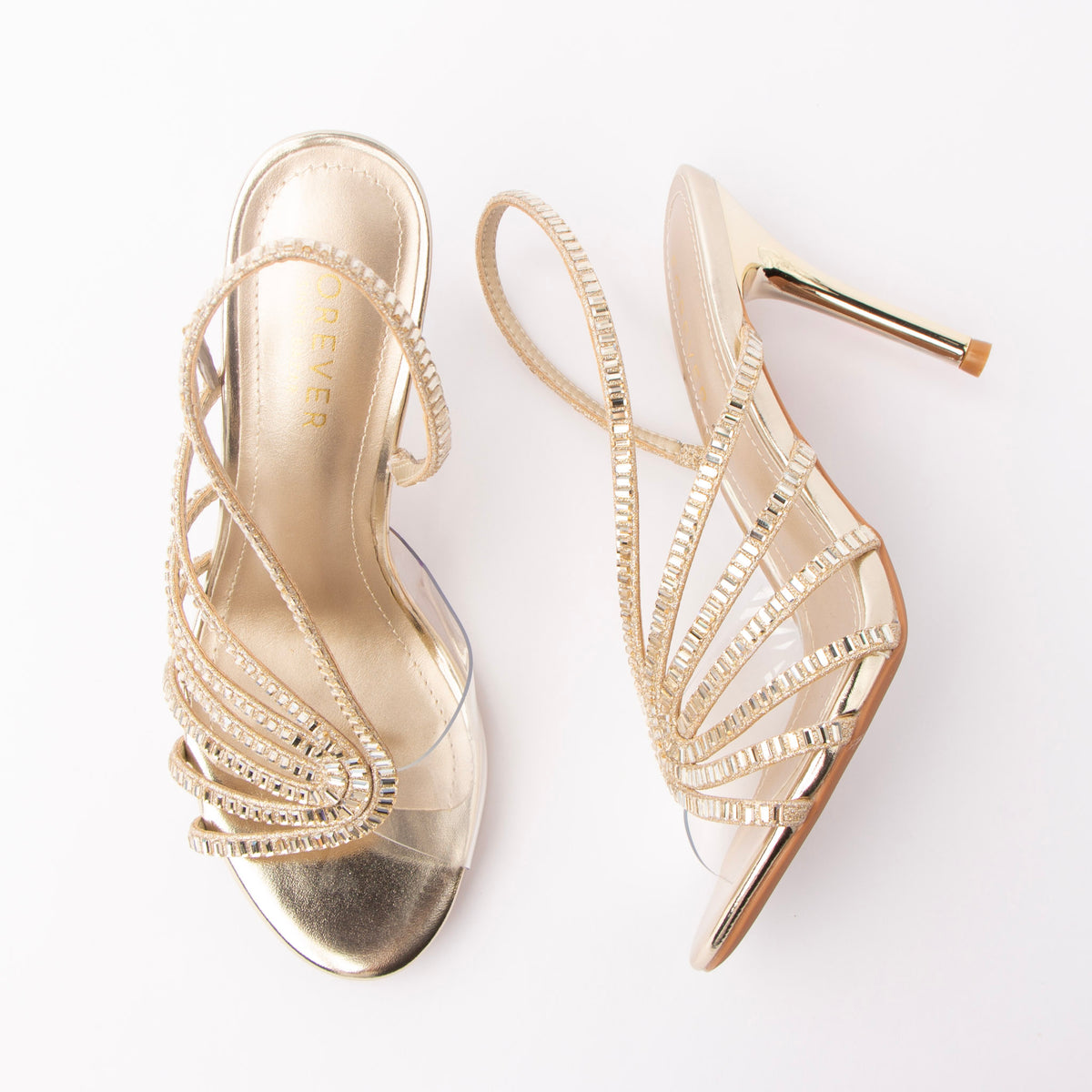Gold sandals for women, both shoes laid flat