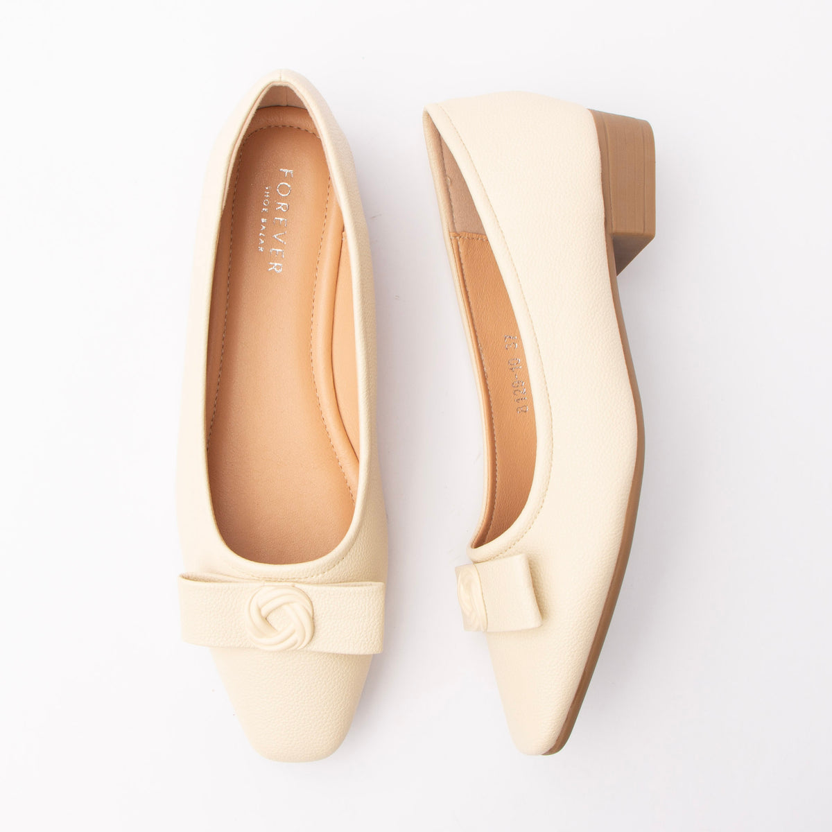 Beige pumps for women, both shoes laid flat