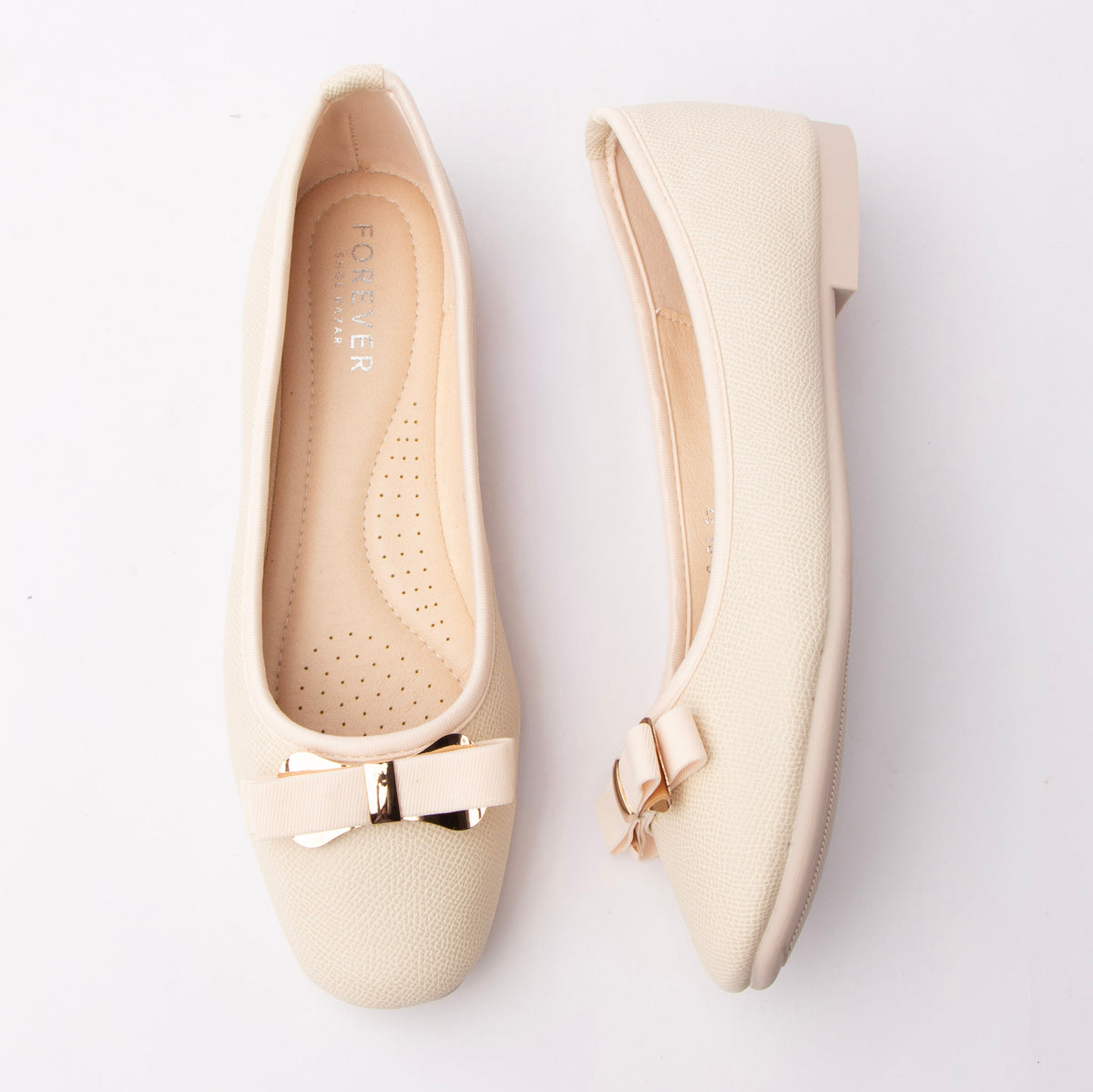 Beige bow ballerina flats styled for everyday wear