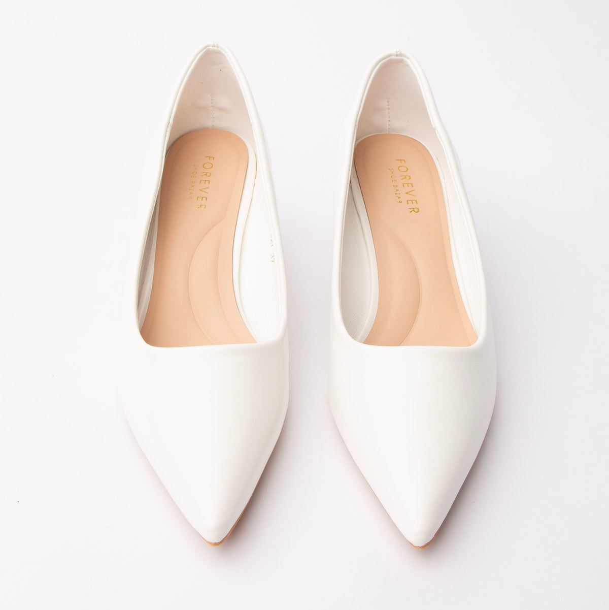 White pointed court shoes styled for everyday wear