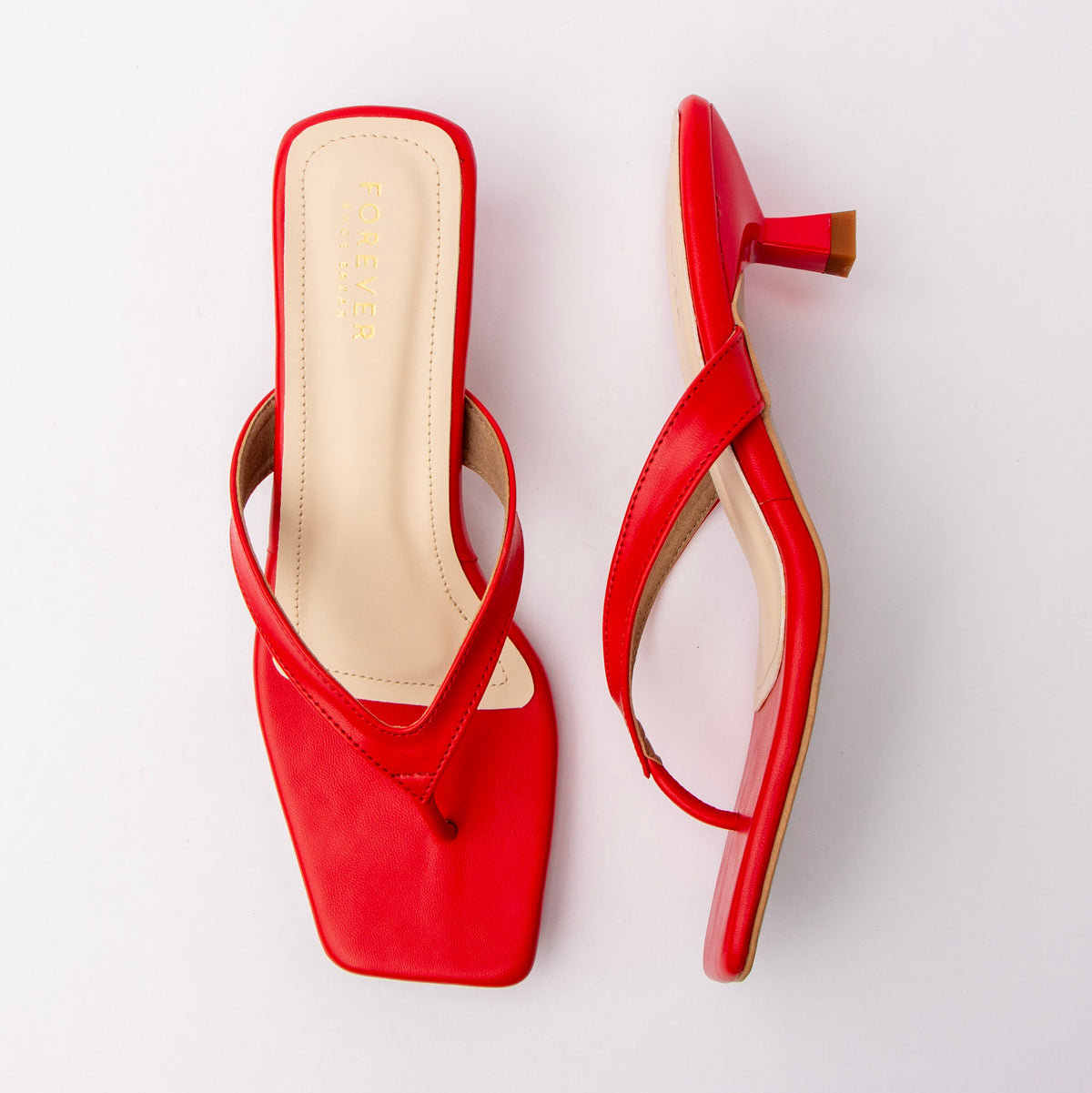 Red toe-post kitten heel mules for women, both shoes laid flat