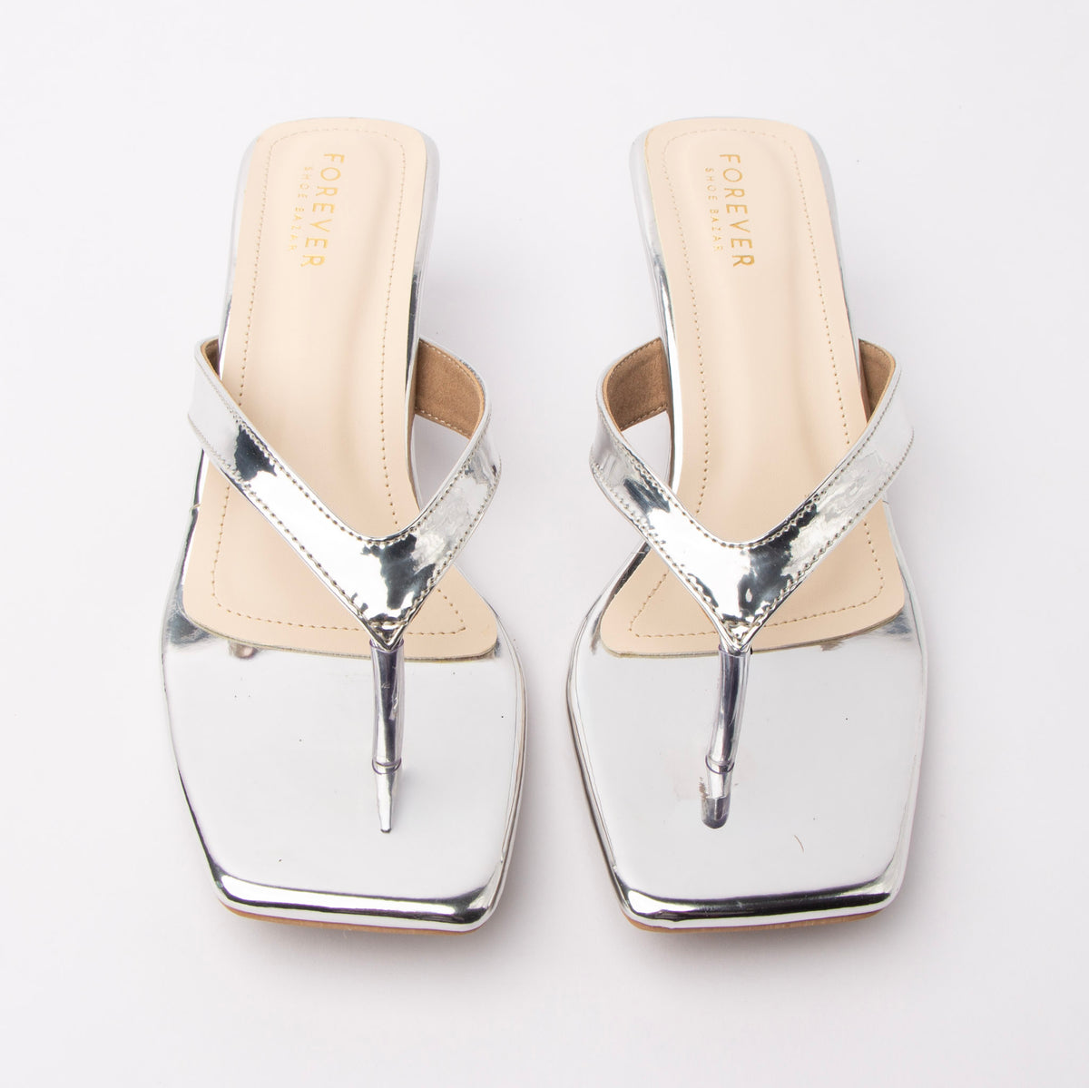 Silver toe-post kitten heel mules for women, both shoes from the front