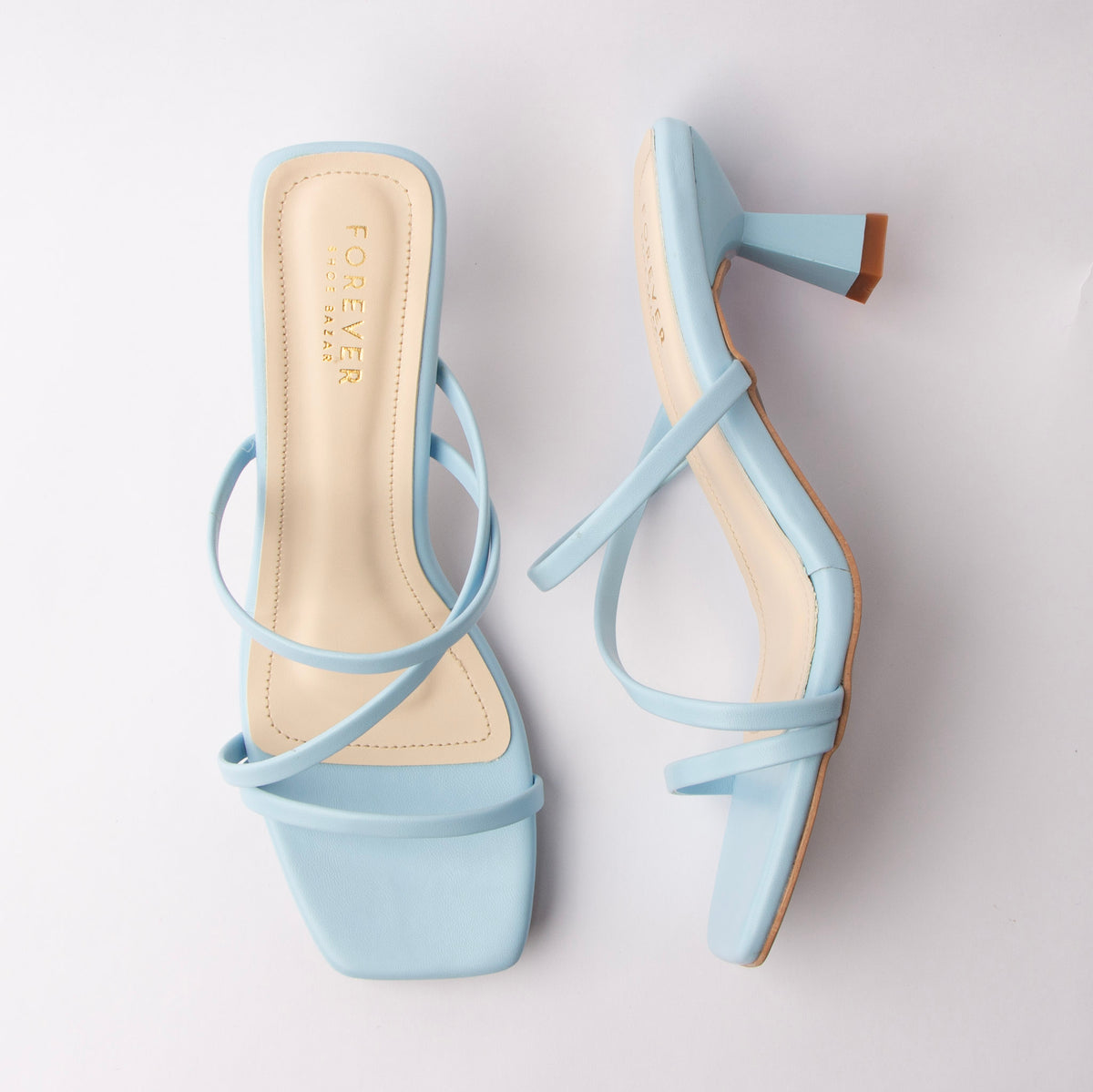 Blue mules for women, both shoes laid flat