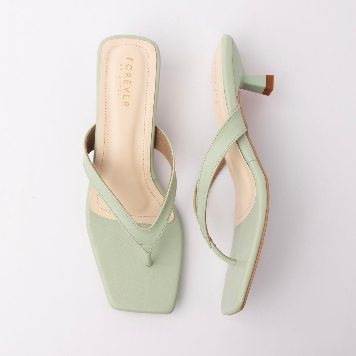 Green toe-post kitten heel mules for women, both shoes laid flat