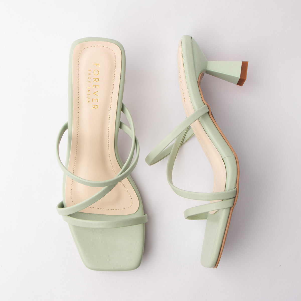 Green mules for women, both shoes laid flat