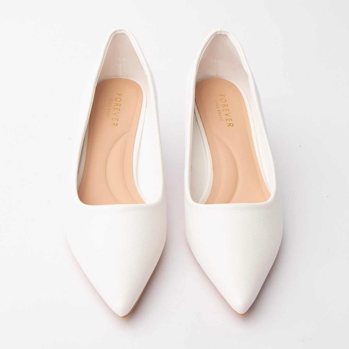 White pointed kitten heels styled for everyday wear