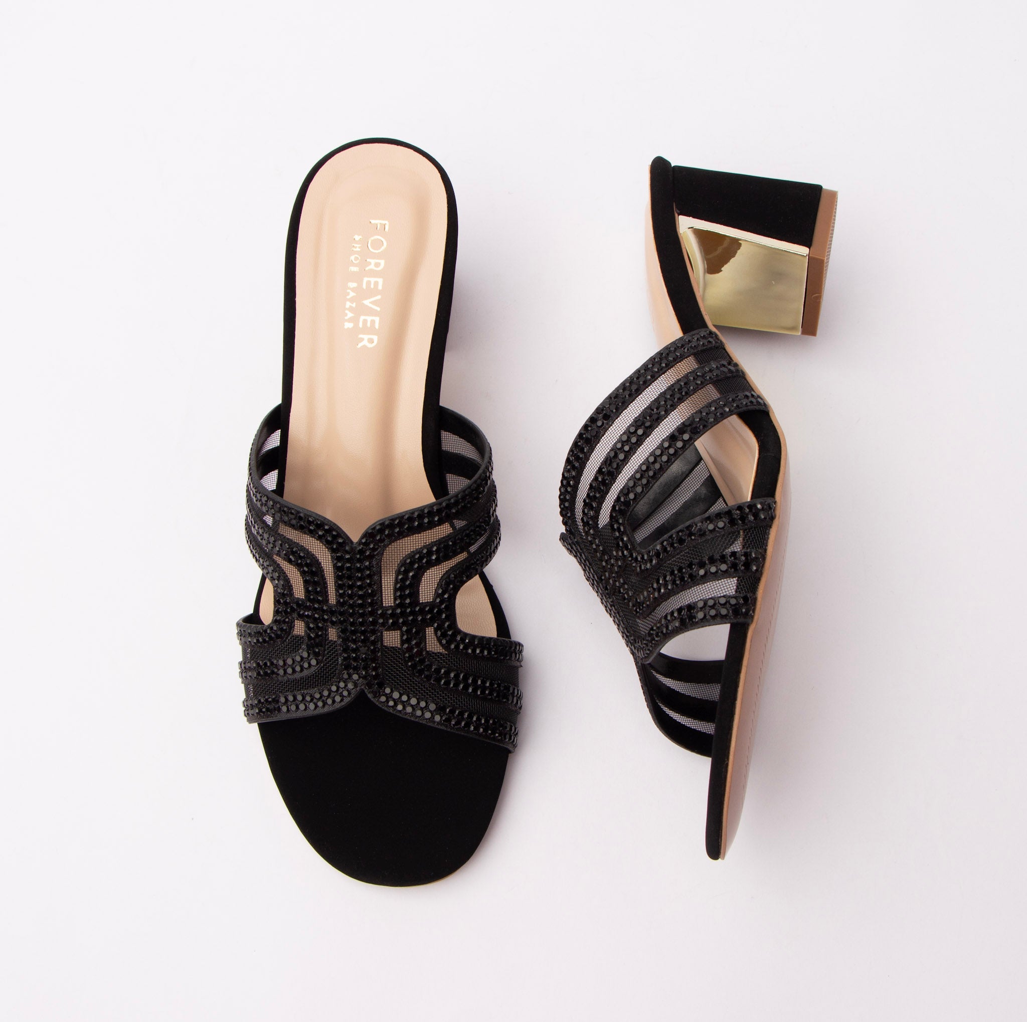 Black block heel mules for women, a butterfly-shaped cut-out vamp built from bead-studded straps over sheer mesh, a nude cushioned footbed stamped in gold, and a suede-finish block heel banded with a mirror-gold plate