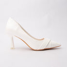 White folded strap pumps for women, a clean bright-white court in smooth faux leather, its toe box wrapped by two broad self-colour bands folded and crossed into a shallow V, on a slender flared hourglass heel tipped in pale silver