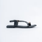 Black flat sandals styled for casual wear