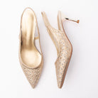 Gold pumps for women, both shoes laid flat