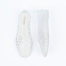 Transparent jelly flats for women, a clear jelly upper moulded into an all-over basket-weave lattice of open diamonds, running unbroken from the closed toe to a full closed back, over a cream branded footbed