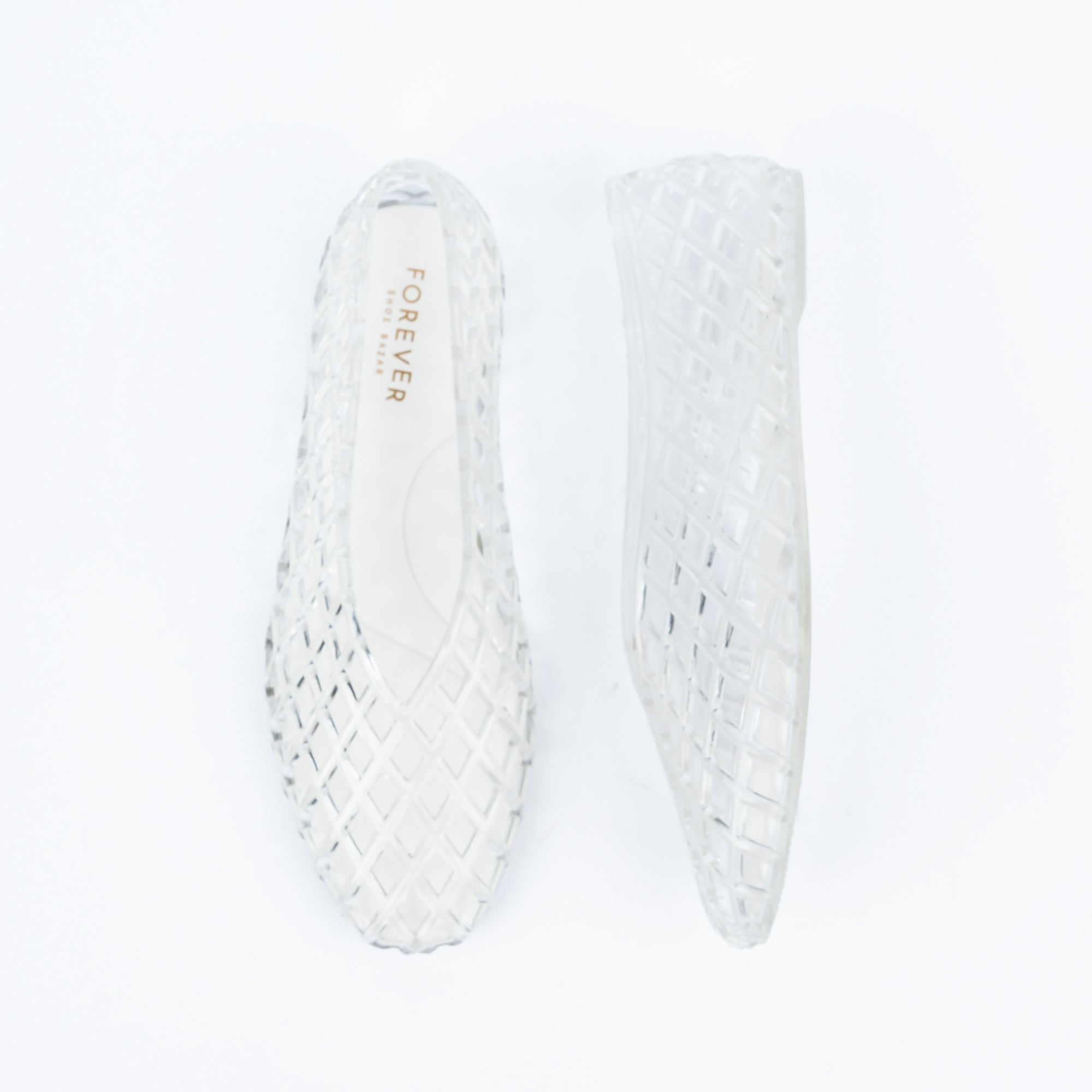 Transparent jelly flats for women, a clear jelly upper moulded into an all-over basket-weave lattice of open diamonds, running unbroken from the closed toe to a full closed back, over a cream branded footbed