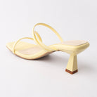 Yellow mules for women, back view showing the heel