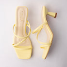 Yellow mules for women, both shoes laid flat