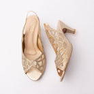 Gold embellished slingback pumps for women, champagne crystal rhinestones outline a scalloped petal motif over nude mesh insets on a shimmering gold glitter upper, with laser-cut teardrops through the quarter, a gathered elastic slingback strap, a smooth metallic gold toe and footbed and a satin gold flared cone kitten heel