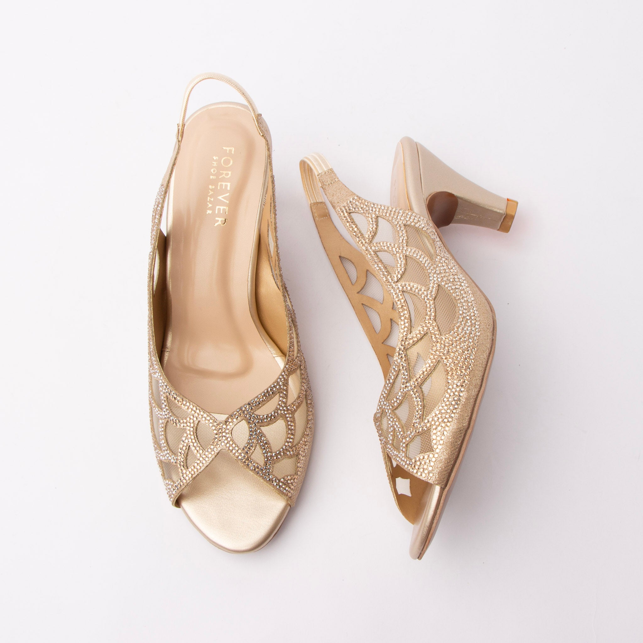 Gold embellished slingback pumps for women, champagne crystal rhinestones outline a scalloped petal motif over nude mesh insets on a shimmering gold glitter upper, with laser-cut teardrops through the quarter, a gathered elastic slingback strap, a smooth metallic gold toe and footbed and a satin gold flared cone kitten heel
