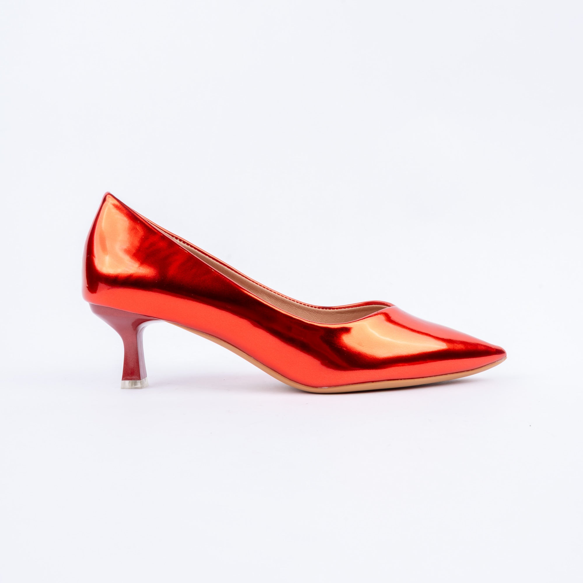 Red pumps for women, an unbroken mirror-finish patent upper drawn to a sharp elongated point, a low-cut topline and a glossy flared spool heel