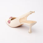 Beige rosette slingback pumps for women with cushioned footbed, side view