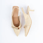 Beige pumps for women, a natural raffia-weave upper crossed by a slim patent vamp strap topped with an elongated gold buckle bar, an elasticated woven slingback, and a flared spool heel