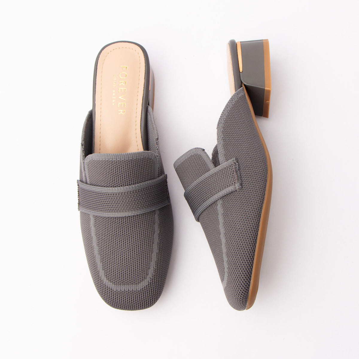 Grey knit loafer mules for women, a grey knitted-mesh loafer mule with a tonal elasticated saddle band, a knit-in apron outline on the squared toe and a low grey block heel finished with a gold metal trim above a nude padded footbed