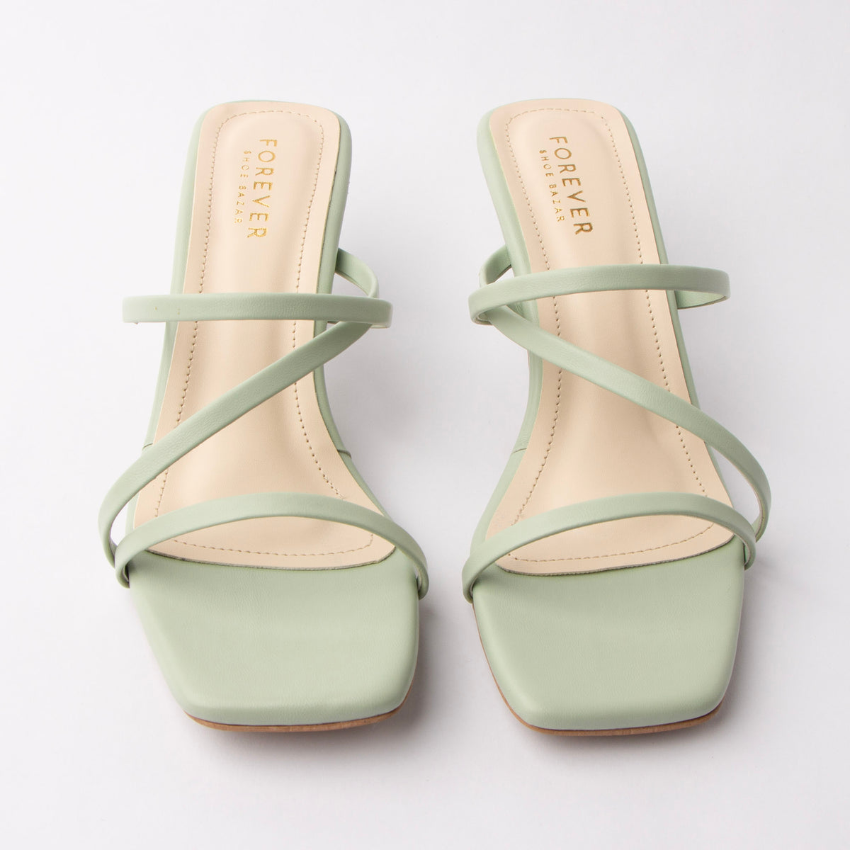 Green mules for women, both shoes from the front