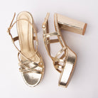 Gold block heel sandals for women, criss-crossing snake-embossed straps over a matching covered platform, a slim pin-buckle ankle loop, and a tall chunky block heel wrapped in the same snake print