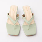 Green toe-post kitten heel mules for women, both shoes from the front