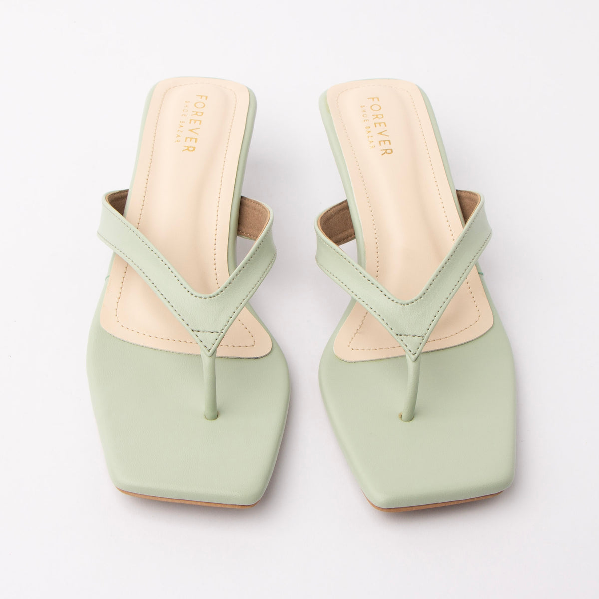 Green toe-post kitten heel mules for women, both shoes from the front