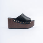 Black wedge heel mules for women, one plain band studded along a wood-look wedge