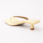 Yellow toe-post kitten heel mules for women, back view showing the heel