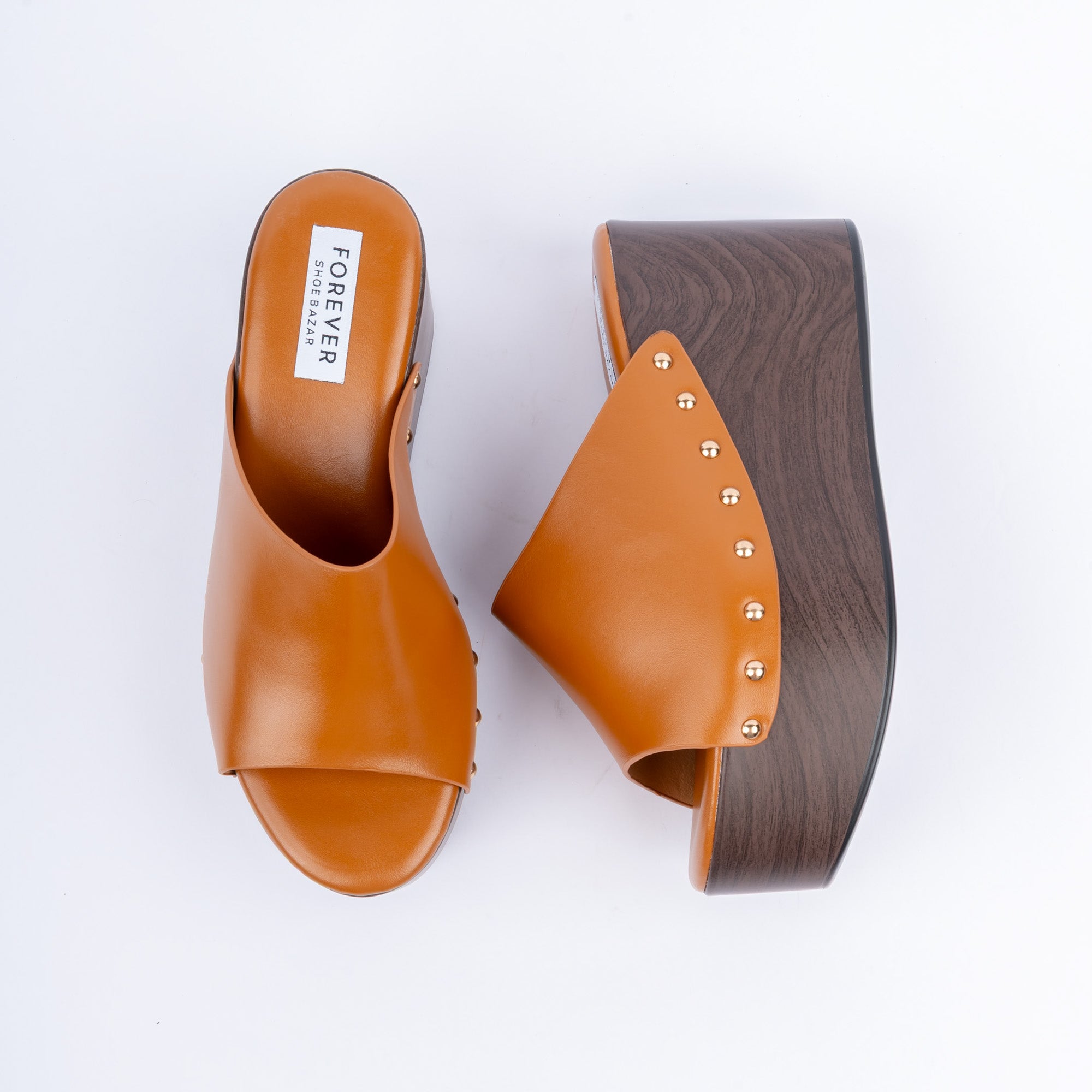 Camel wedge heel mules for women, one plain band studded along a wood-look wedge