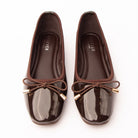 Brown patent ballerina flats styled for everyday wear