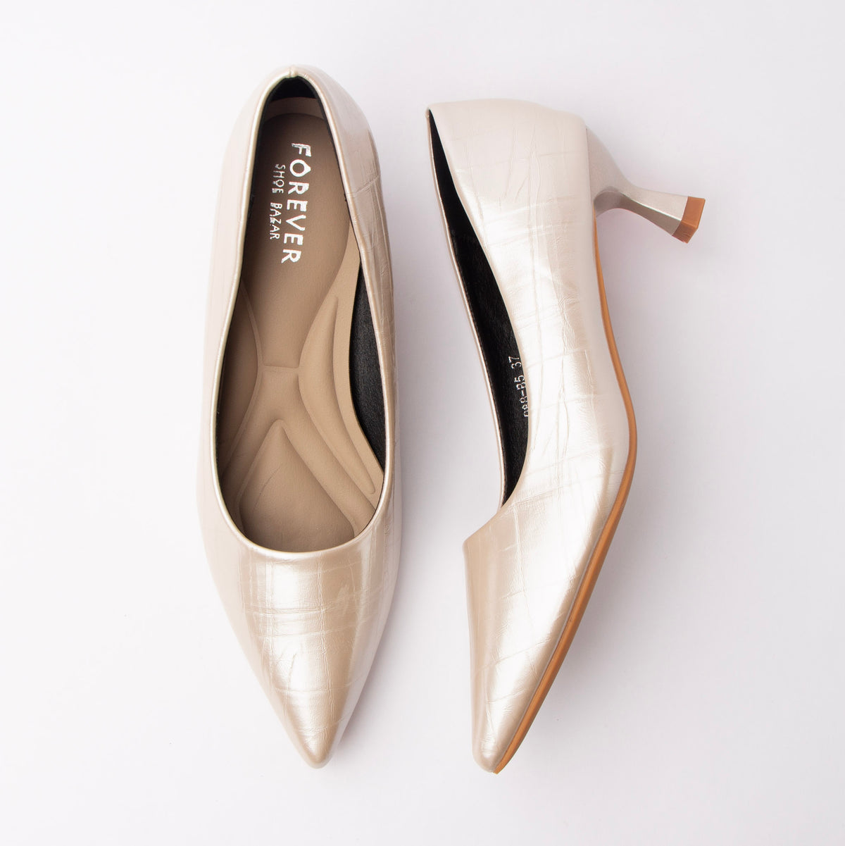 Beige pumps for women, both shoes laid flat