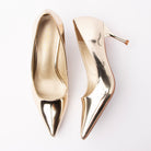 Gold pumps for women, both shoes laid flat