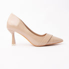 Beige folded strap pumps for women, a warm greige-nude court whose toe box is wrapped by two wide self-colour bands folded and crossed into a shallow V, on a slender flared hourglass heel splaying to a squared base tipped in pale silver