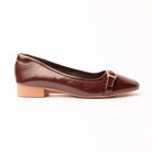 Brown buckle ballerinas for women, a dark chocolate patent-look ballerina with a faintly creased surface, a narrow matching strap closing through a small gold buckle, on a low stacked heel and sole edge in natural tan