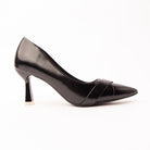 Black folded strap pumps for women, a high-shine black court whose toe box is wrapped by two broad self-colour bands folded across one another into a shallow V that catches the light along each fold, on a slender flared hourglass heel tipped in pale silver