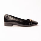 Black buckle ballerinas for women, a high-shine black patent-look ballerina with a lightly crinkled surface, a narrow self-colour strap fastening off-centre through a small gold buckle, on a low black stacked heel