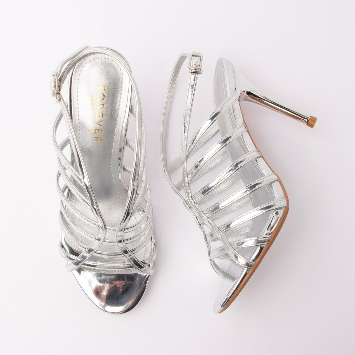 Silver sandals for women, both shoes laid flat