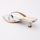 Silver toe-post kitten heel mules for women, back view showing the heel