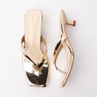 Gold toe-post kitten heel mules for women, both shoes laid flat