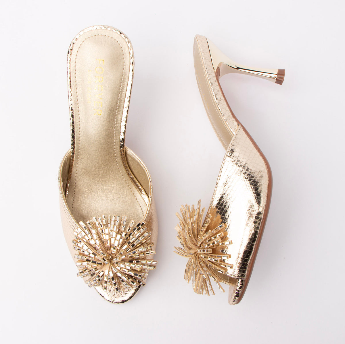 Gold mules for women, both shoes laid flat
