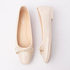 Cream patent ballerina flats for women with a cushioned footbed
