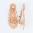 Beige flat sandals for women, translucent nude jelly V-straps set with rows of iridescent round crystals running down to a slim toe post, on a moulded jelly footbed