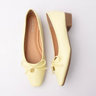 Yellow pumps for women, both shoes laid flat