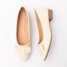 Beige pumps for women, both shoes laid flat